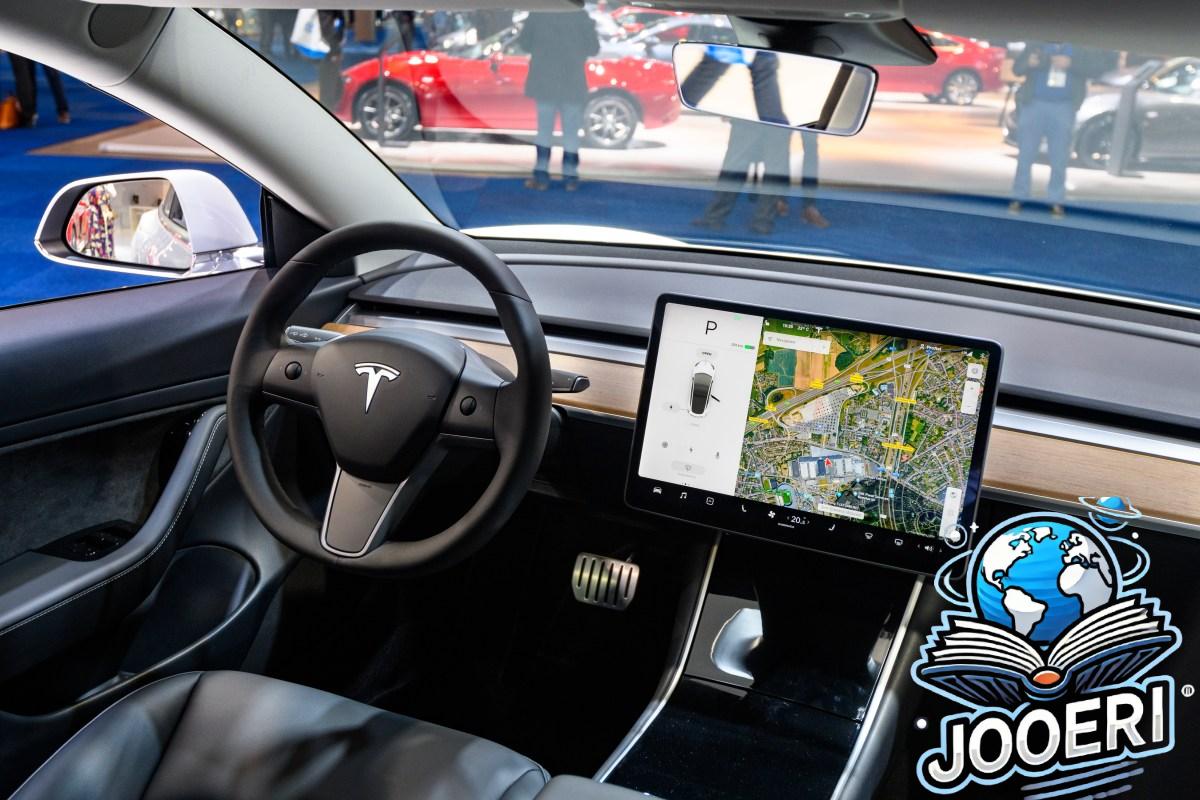 Tesla Model 3 compact full electric car interior with a large touch screen on the dashboard.