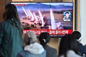 People watch a television screen showing a news broadcast with file footage of a North Korean missile test, at a railway station in Seoul on April 22, 2024. North Korea has fired an unidentified ballistic missile into the sea off South Korea's east coast.