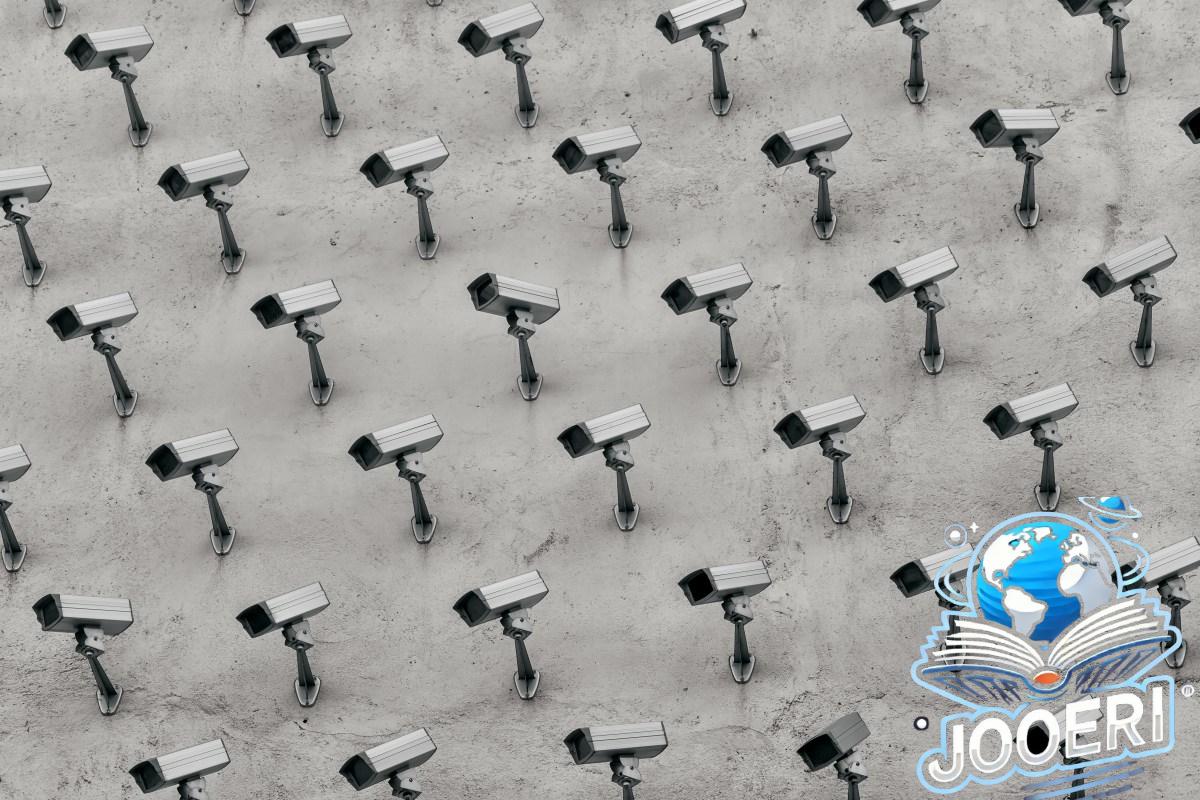 a pattern of CCTV surveillance cameras on a wall, all pointing in different directions.