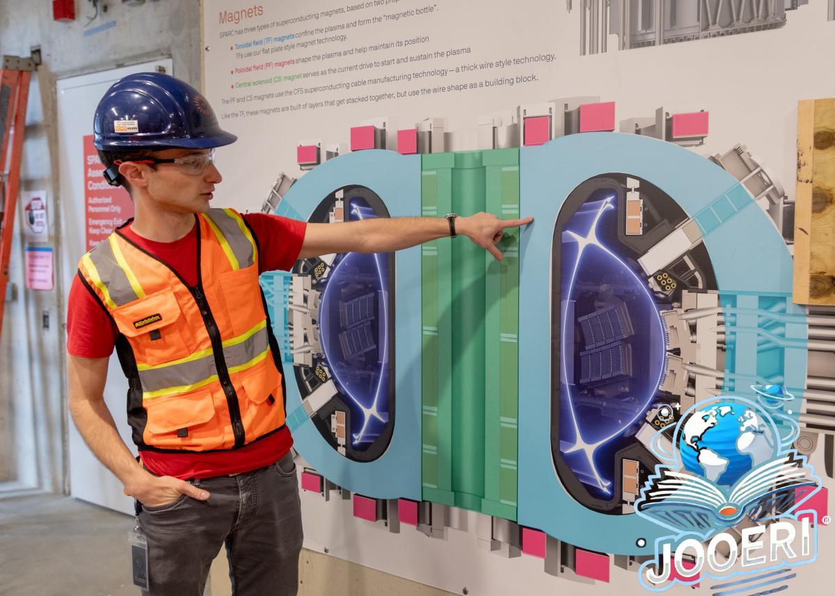 Alex Creely, director of Tokamak operations at Commonwealth Fusion Systems, points to a reactor schematic.