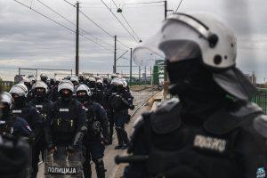 a photo of Serbian police units in riot gear guard the entrance to the Old Sava Bridge in Belgrade on November 20, 2024, during of a protest