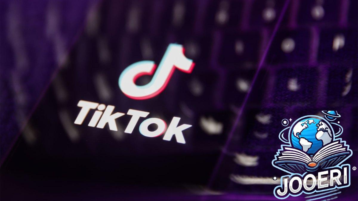 A laptop keyboard and TikTok logo displayed on a phone screen are seen in this multiple exposure illustration.