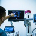 Doctor examining breasts with mammogram