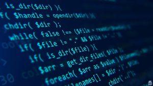 Blue code on a dark background presented at an angle.