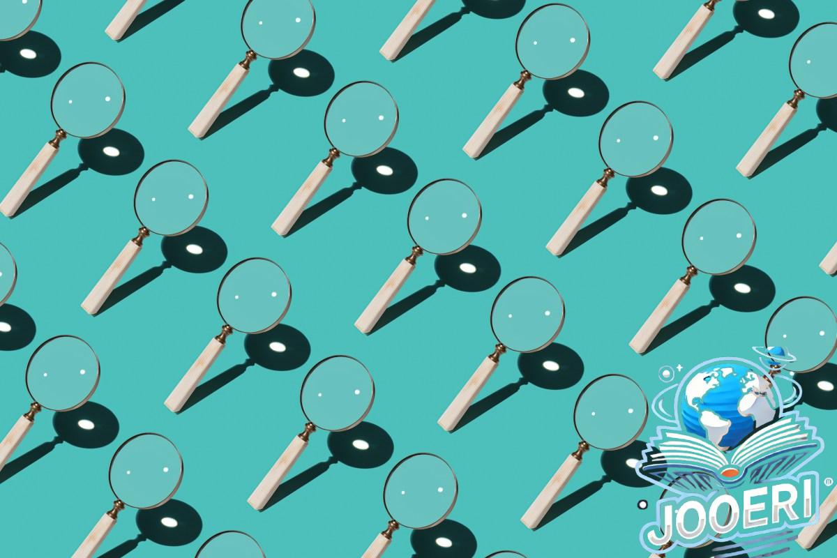 Magnifying Glass Focusing Sunlight Into a Point Repetition on Turquoise Colored Background High Angle View.