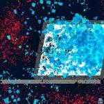 an illustrated laptop on a red darkened background, with blue flakes of data spilling out of the laptop's screen — indicating a data spill/leak.