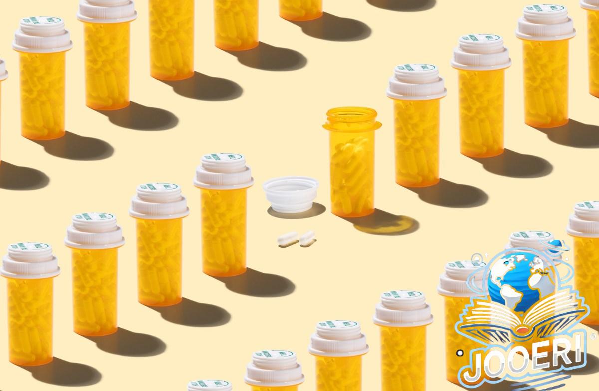 An Opened Prescription Medicine Bottle Among Many Other Sealed Bottles on Yellow Background High Angle View.