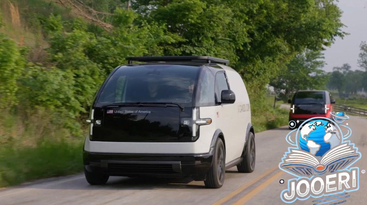 Two Canoo EVs drive on a road in Bentonville, Arkansas.