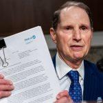 Sen. Ron Wyden (D-OR) holds up witness testimony during a Senate Finance Committee hearing on abuse at youth residential treatment facilities at the U.S. Capitol on June 12, 2024 in Washington, DC.