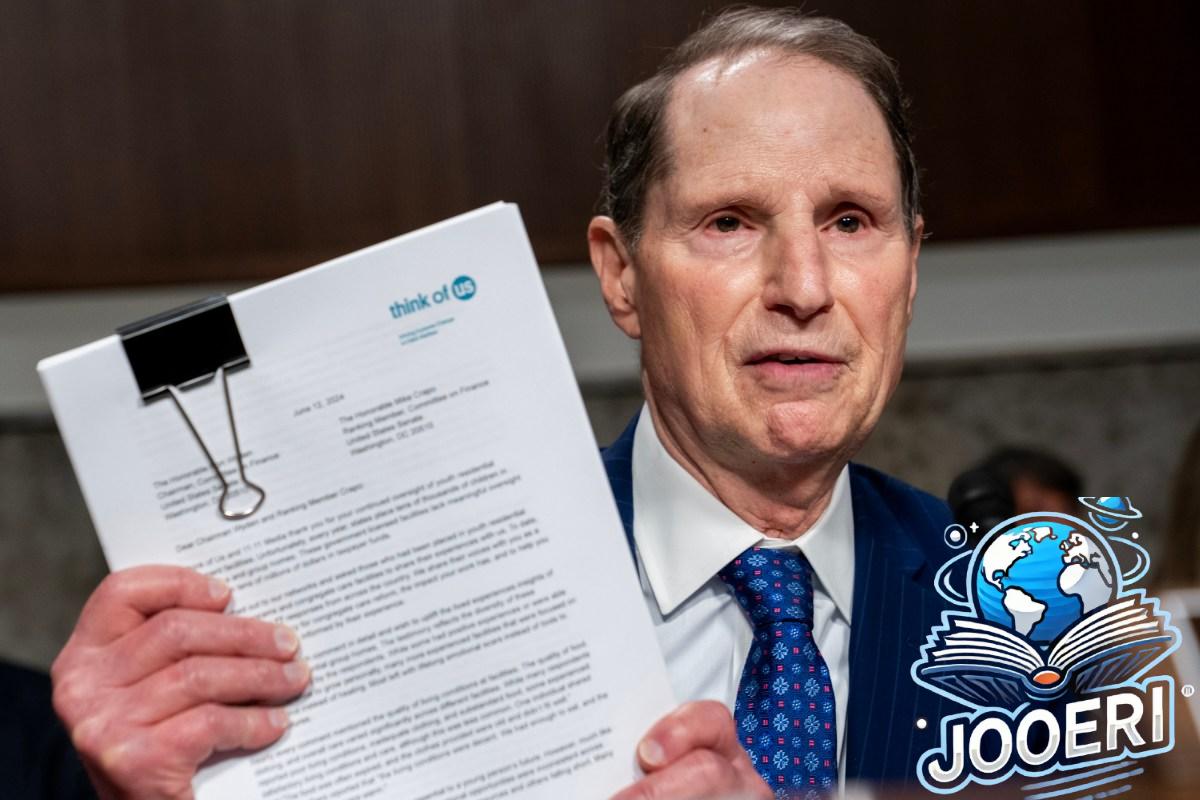 Sen. Ron Wyden (D-OR) holds up witness testimony during a Senate Finance Committee hearing on abuse at youth residential treatment facilities at the U.S. Capitol on June 12, 2024 in Washington, DC.