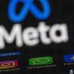 The apps Instagram, Facebook and WhatsApp can be seen on the display of a smartphone in front of the logo of the Meta internet company.