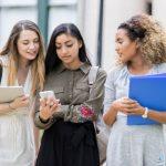 College students reading text on smartphone